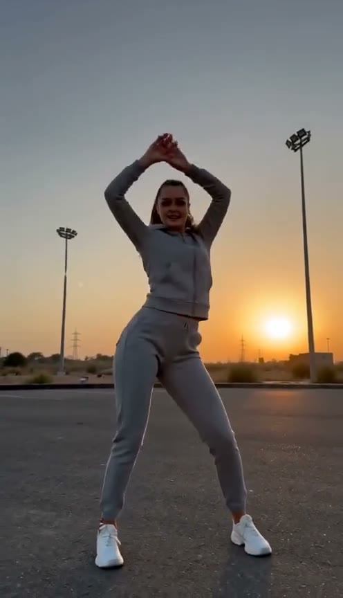 Gas station dance trend shot 1: freestyle dance on an empty lot at dusk